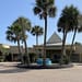 Entrance to the Four Points in Fort Walton Beach. Palm trees and a water fountain.